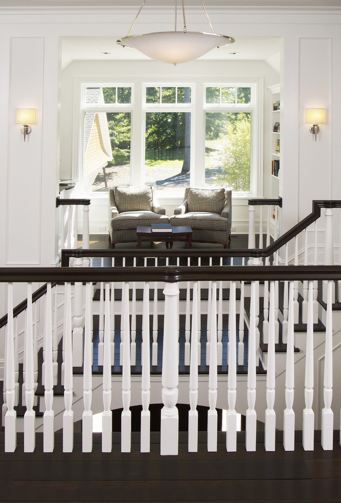 Large transitional wooden u-shaped staircase photo in Grand Rapids with painted risers