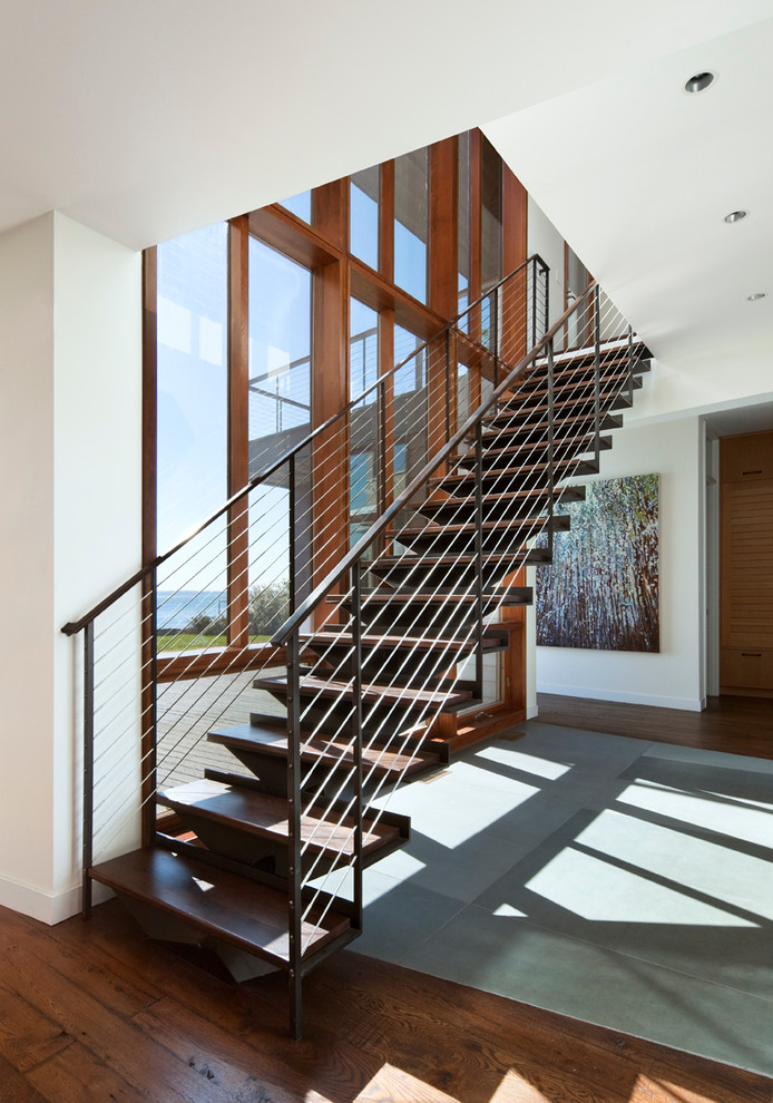 Coastal wood floating staircase in New York with metal risers.