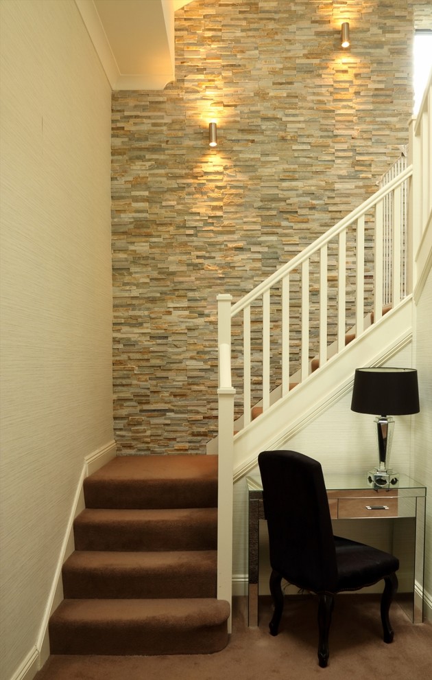 Photo of a classic carpeted l-shaped staircase in Other with carpeted risers and feature lighting.