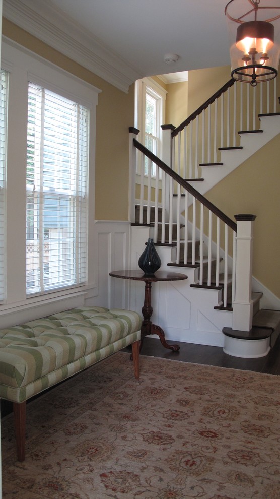 Photo of a medium sized traditional carpeted u-shaped wood railing staircase in New York with carpeted risers.