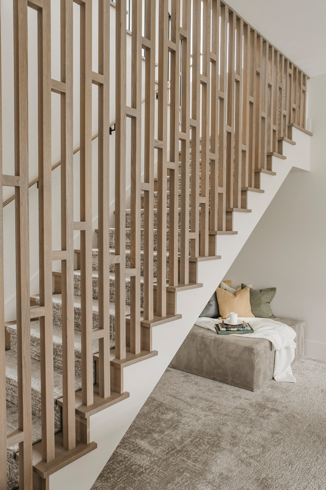Medium sized contemporary carpeted u-shaped wood railing staircase in Austin with carpeted risers.