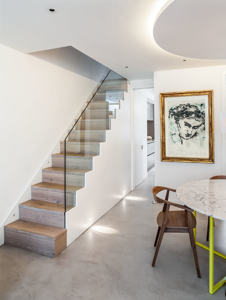 Design ideas for a contemporary wood straight staircase in London with wood risers.