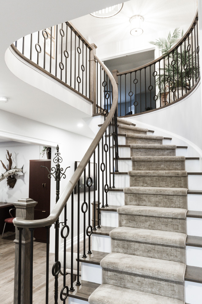 Staircase - mid-sized transitional wooden curved wood railing staircase idea in Toronto with painted risers