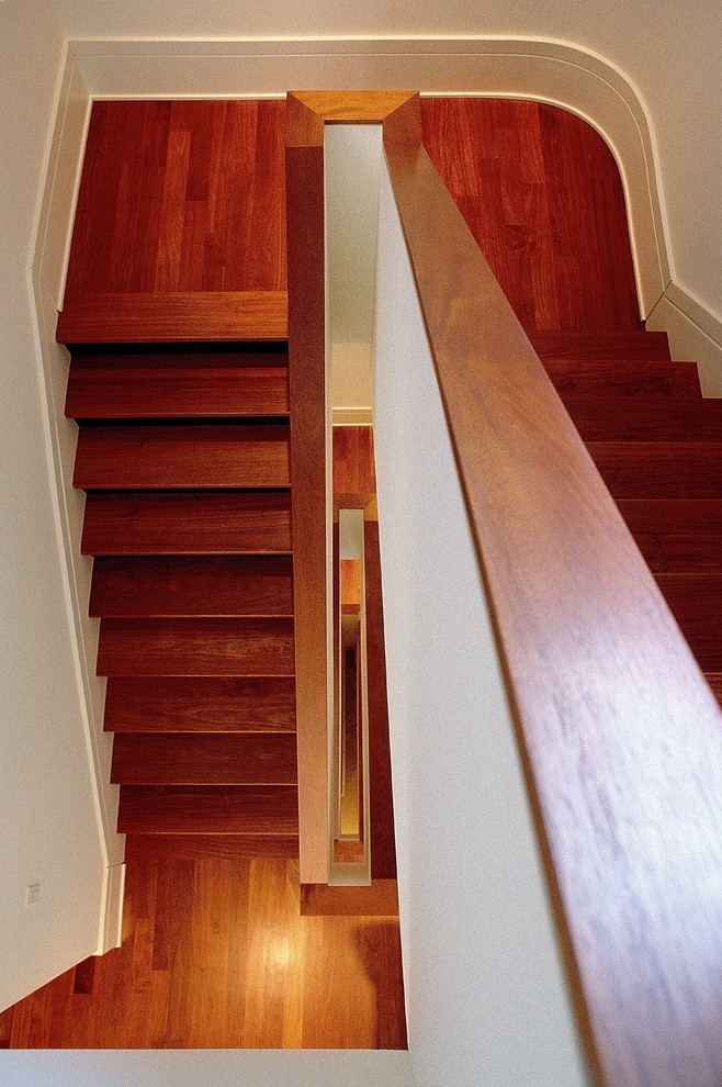 Photo of a large classic wood u-shaped wood railing staircase in Philadelphia with painted wood risers.