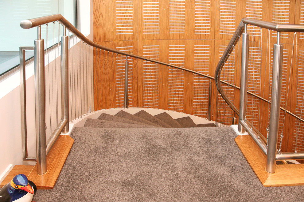 Inspiration for a classic carpeted curved staircase in Wellington with carpeted risers.
