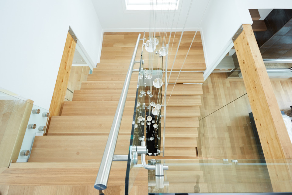 Design ideas for a modern wood floating staircase in Edmonton with wood risers.