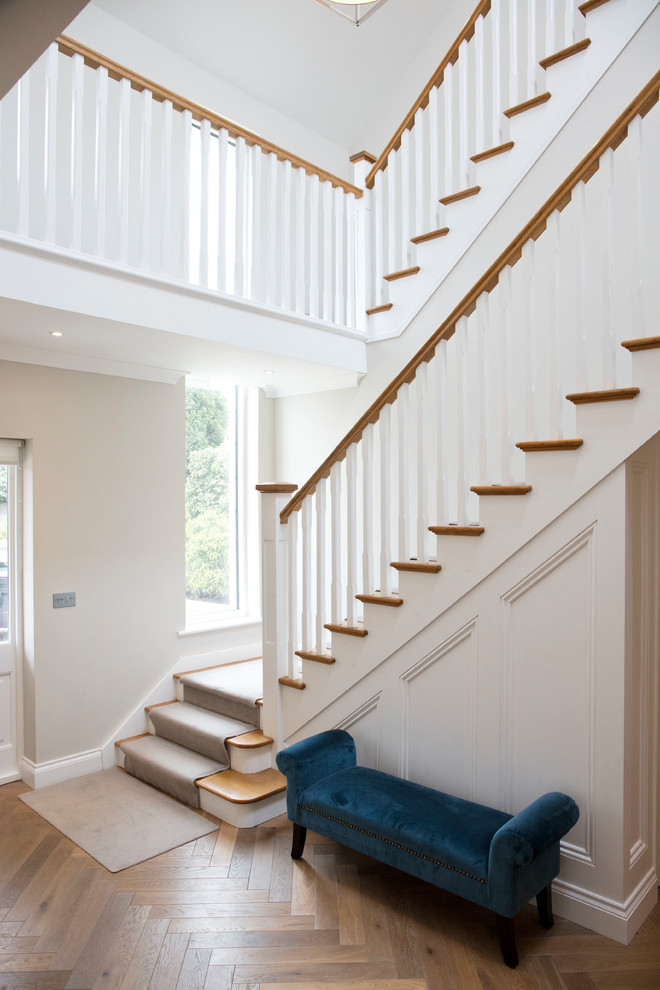 Design ideas for a traditional carpeted wood railing staircase in Dublin with wood risers.
