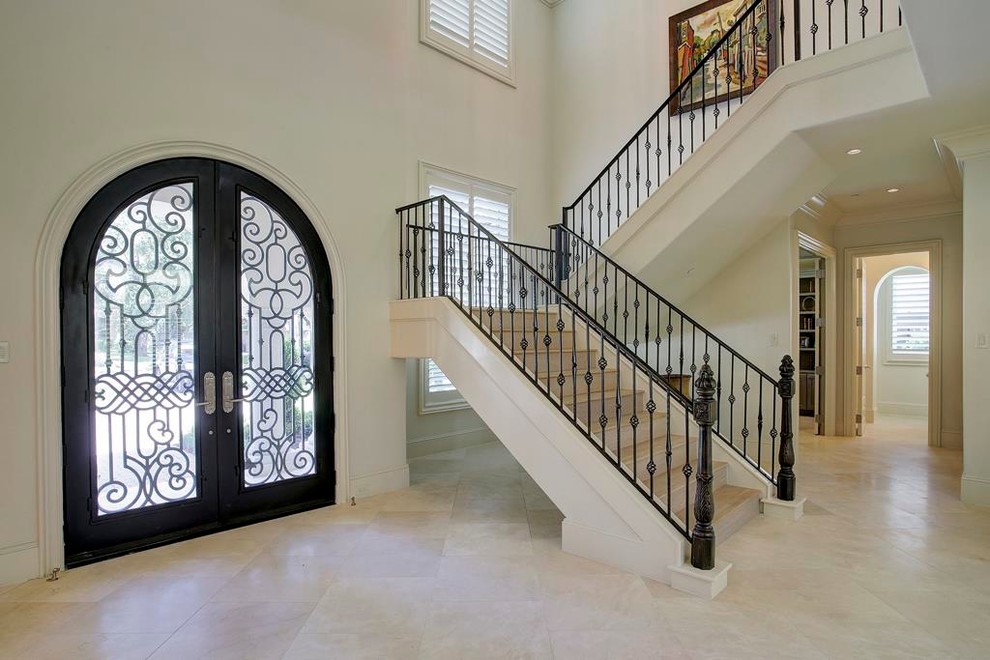 Staircase - huge mediterranean wooden u-shaped staircase idea in Houston with wooden risers