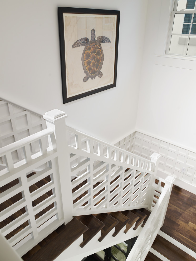 Inspiration for a mid-sized tropical wooden u-shaped wood railing staircase remodel in Tampa with painted risers