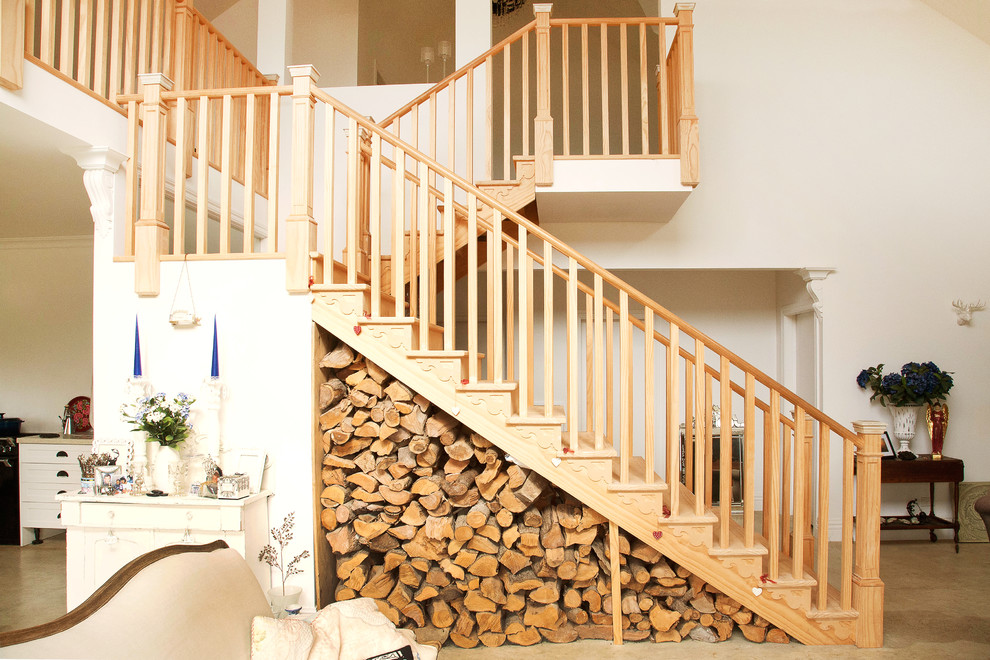 Design ideas for a farmhouse wood u-shaped staircase in Wellington with wood risers.