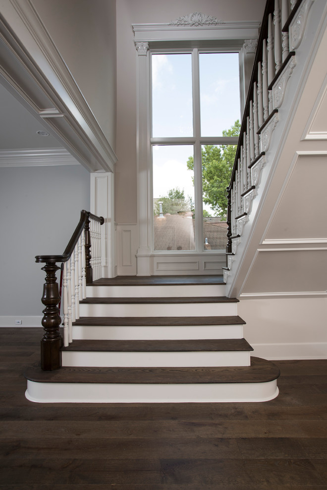 Example of a huge classic l-shaped wood railing staircase design in Houston with wooden risers