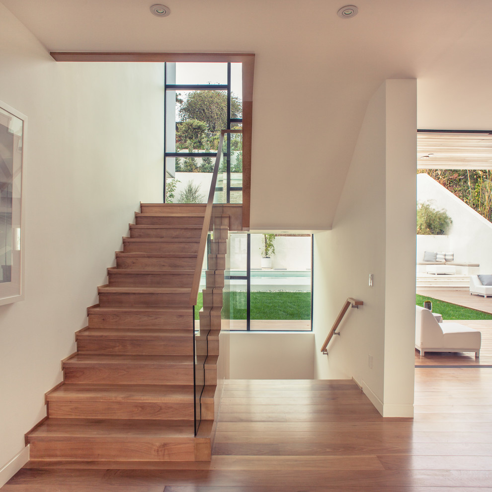 Trendy wooden u-shaped staircase photo in Los Angeles with wooden risers
