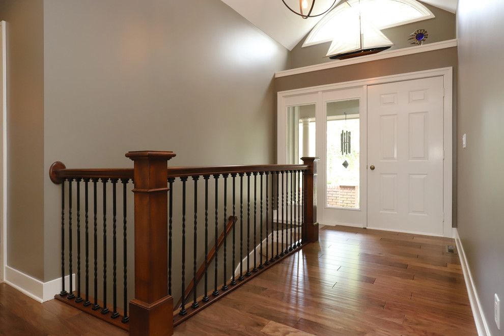 Example of a mid-sized classic carpeted straight wood railing staircase design in Grand Rapids with carpeted risers