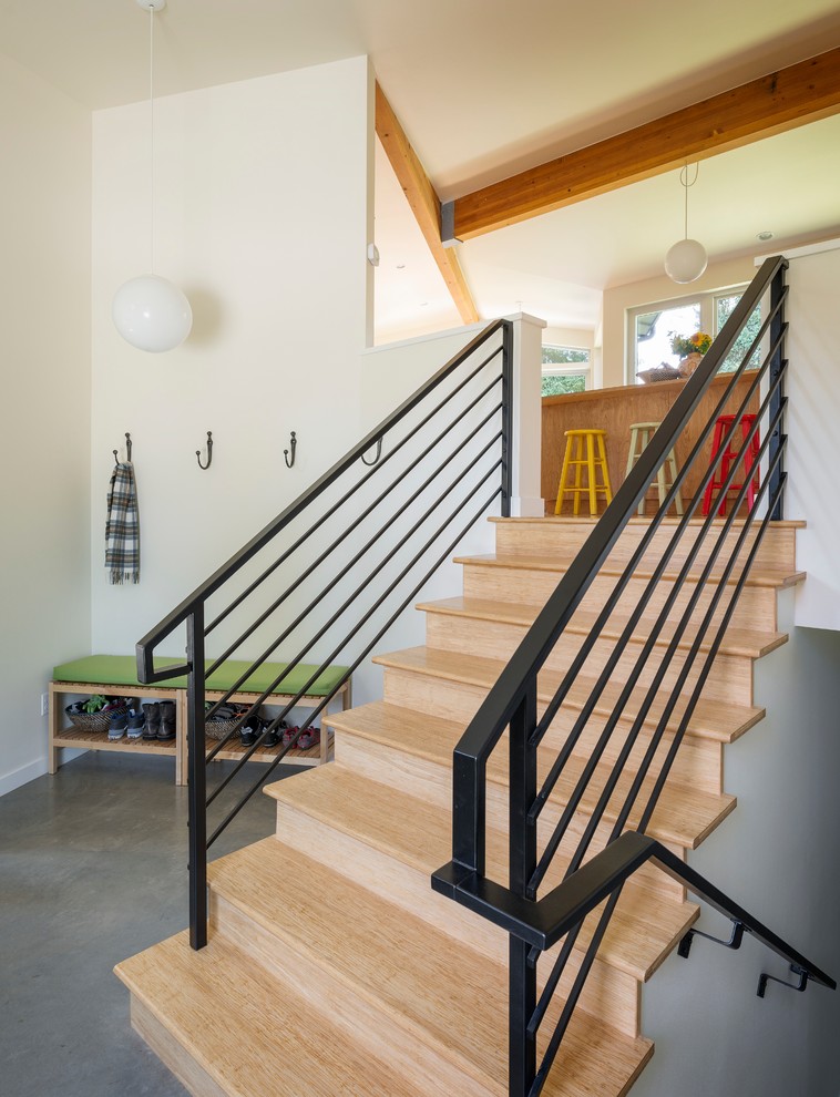 Inspiration for a midcentury wood straight staircase in Seattle with wood risers.
