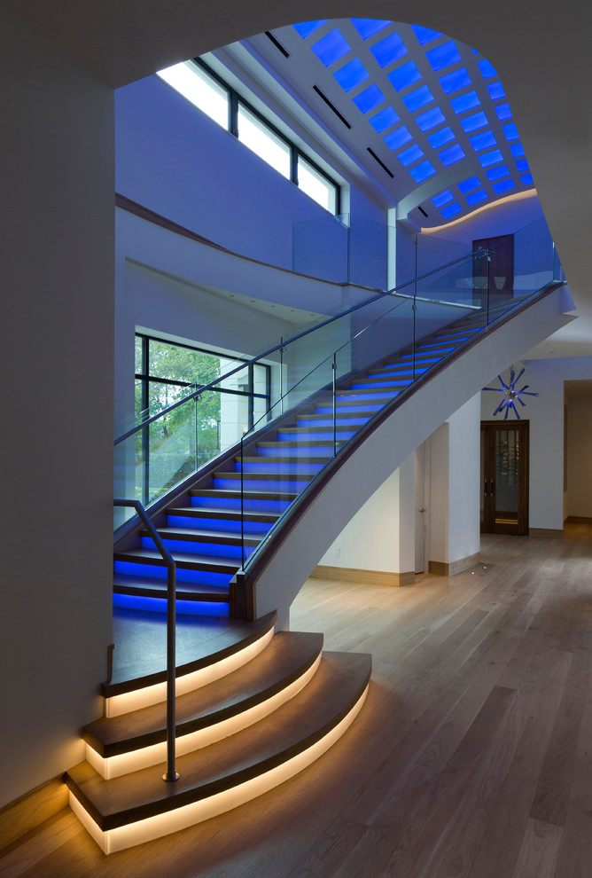 Photo of a large eclectic wood straight staircase in Houston with painted wood risers.