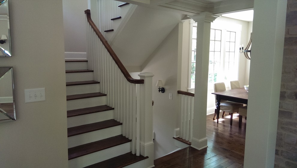 Staircase - large craftsman wooden u-shaped staircase idea in Raleigh with wooden risers