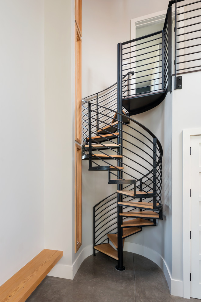 Large rustic wood spiral staircase in San Francisco with open risers.