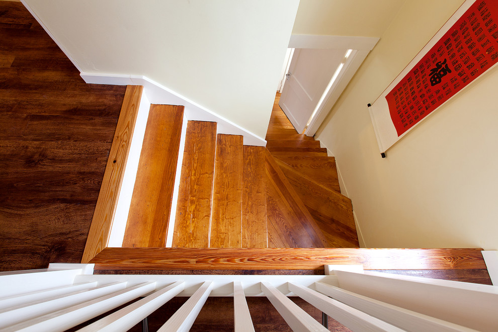 Inspiration for a medium sized contemporary wood l-shaped wood railing staircase in Boston with painted wood risers.