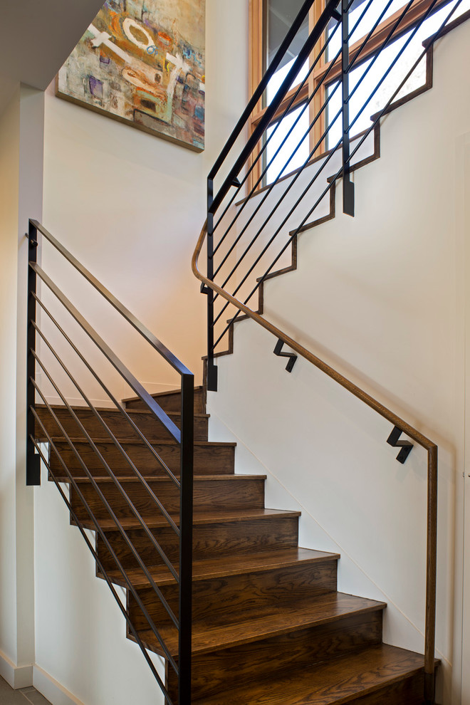 Inspiration for a mid-sized contemporary wooden u-shaped metal railing staircase remodel in Charlotte with wooden risers
