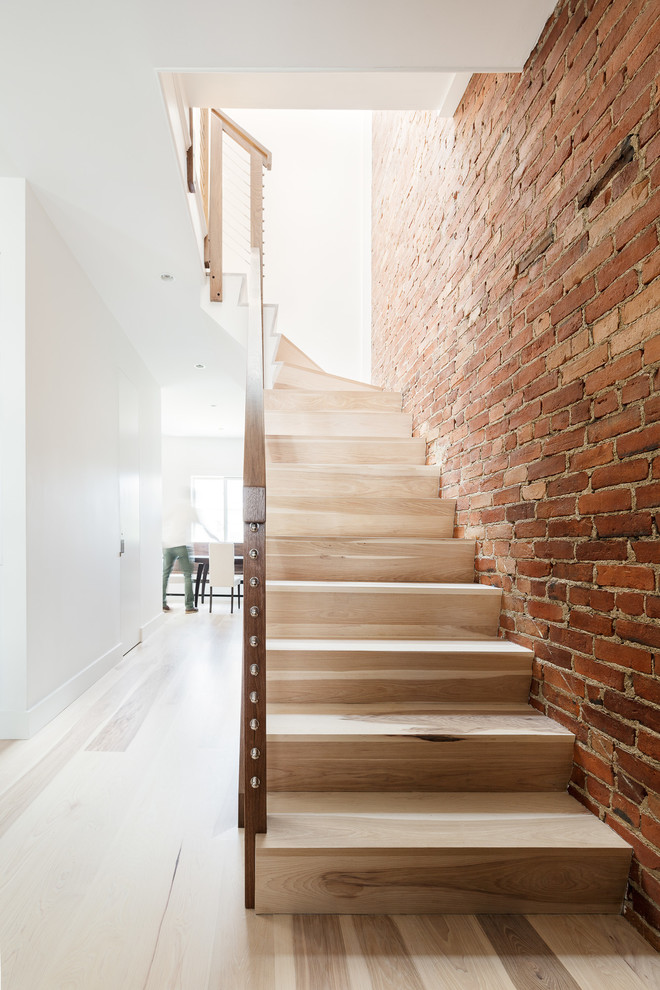 Inspiration for a large modern wood l-shaped wire cable railing staircase in Boston with wood risers.
