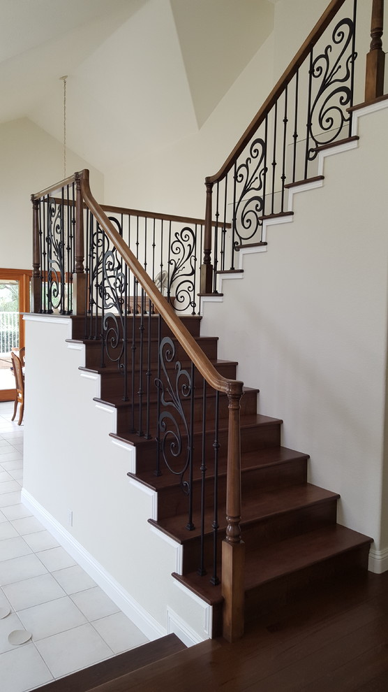 Medium sized traditional wood u-shaped mixed railing staircase in Los Angeles with wood risers.