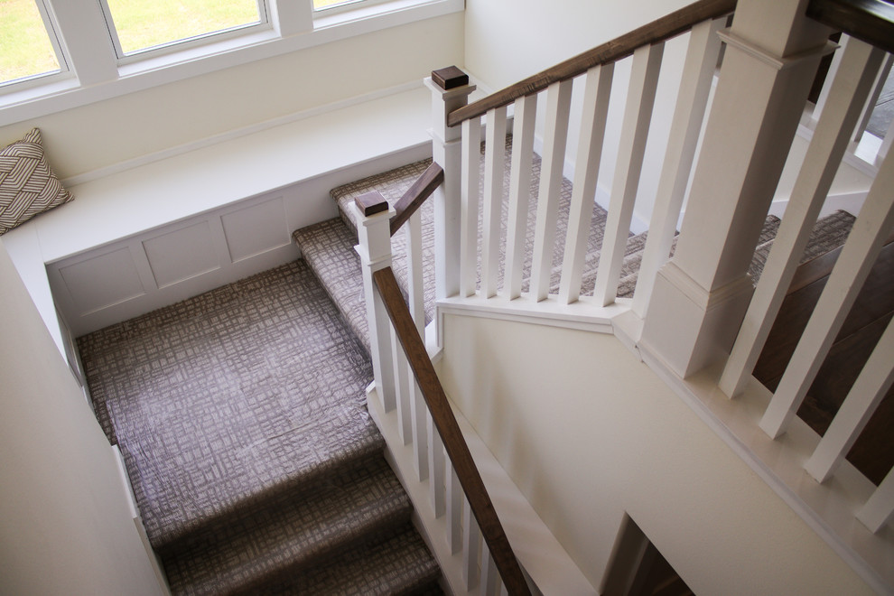 Inspiration for a mid-sized contemporary carpeted u-shaped wood railing staircase remodel in Other with carpeted risers