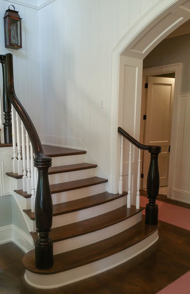 Elegant wooden u-shaped staircase photo in Atlanta with painted risers