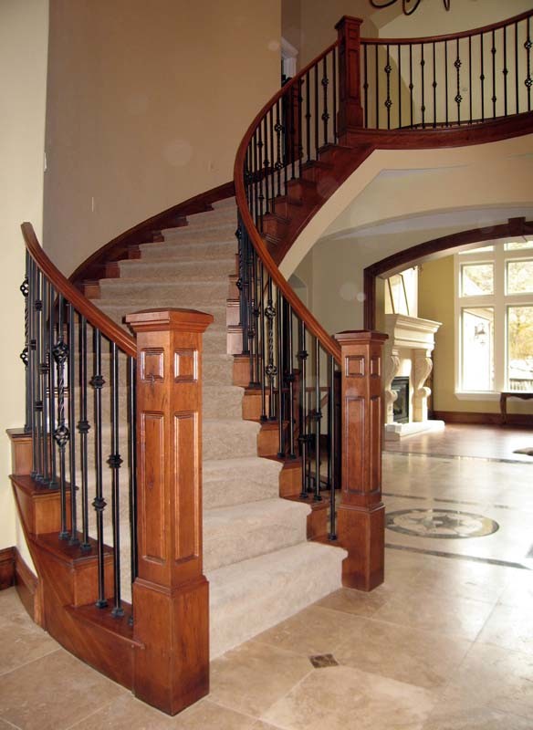 Aménagement d'un grand escalier courbe classique avec des marches en moquette et des contremarches en moquette.