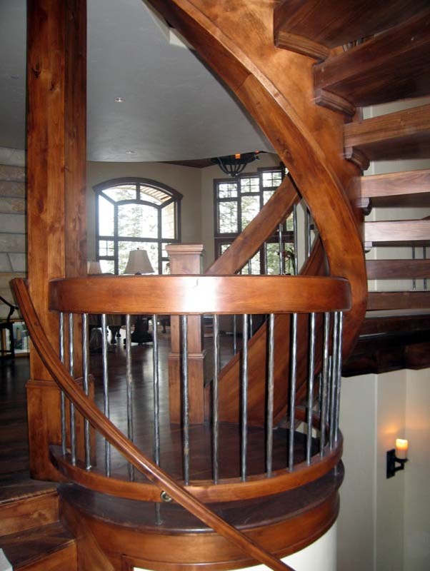 Large elegant wooden curved open staircase photo in Salt Lake City