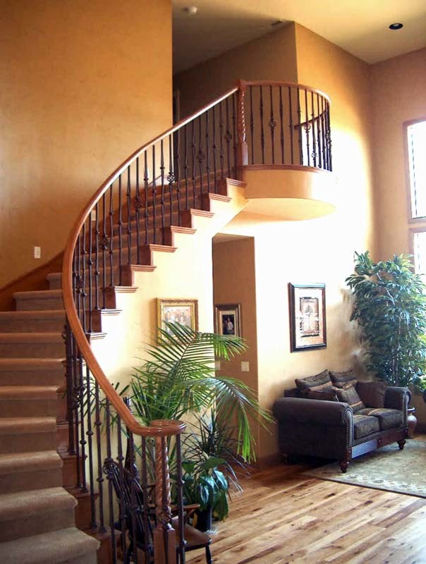 This is an example of a classic carpeted curved staircase in Salt Lake City with carpeted risers.