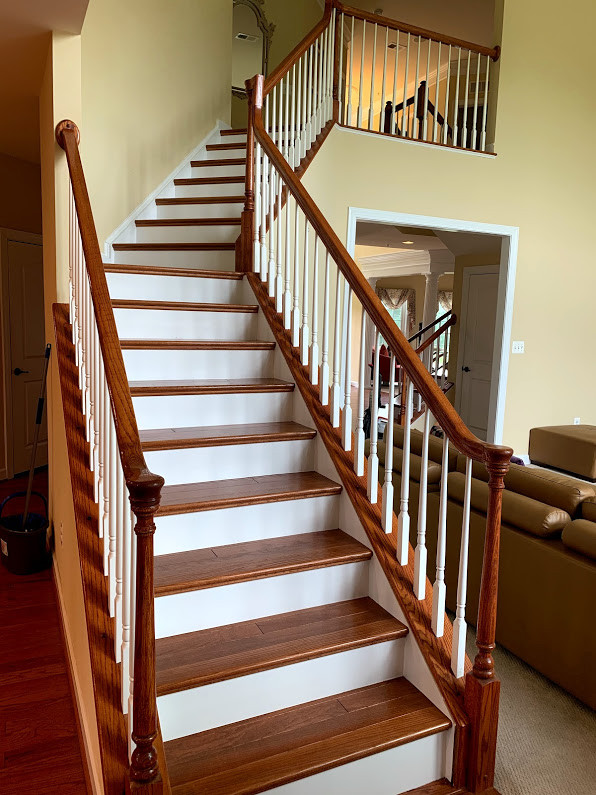 Photo of a medium sized classic wood l-shaped wood railing staircase in Baltimore with wood risers.