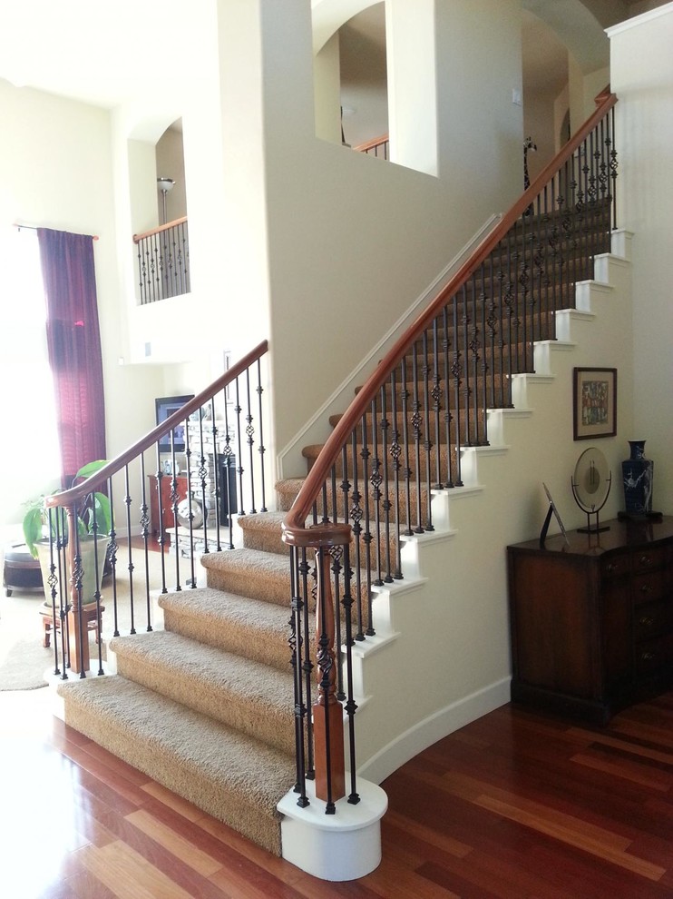 Mid-sized elegant carpeted curved staircase photo in Sacramento with carpeted risers