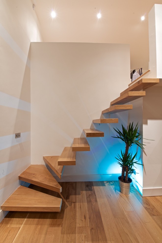 Inspiration for a contemporary wood floating staircase in Dublin with wood risers.