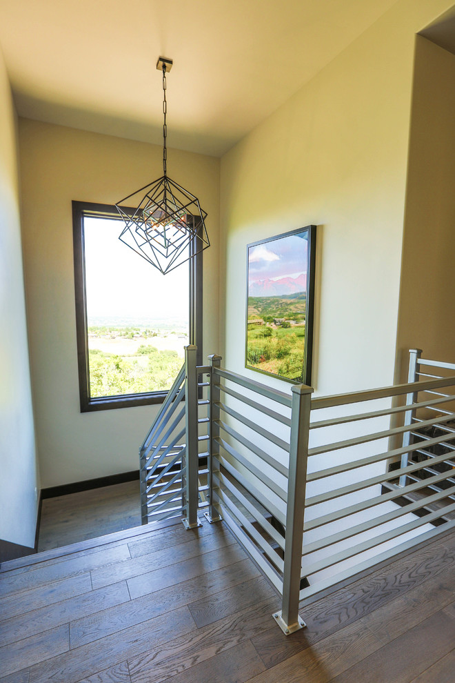 Design ideas for a large modern wood u-shaped metal railing staircase in Salt Lake City with wood risers.