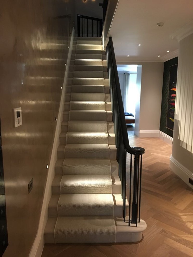 Inspiration for a large timeless marble straight metal railing staircase remodel in London with marble risers