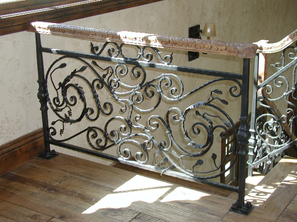 Photo of a large traditional wood l-shaped mixed railing staircase in Other with wood risers.