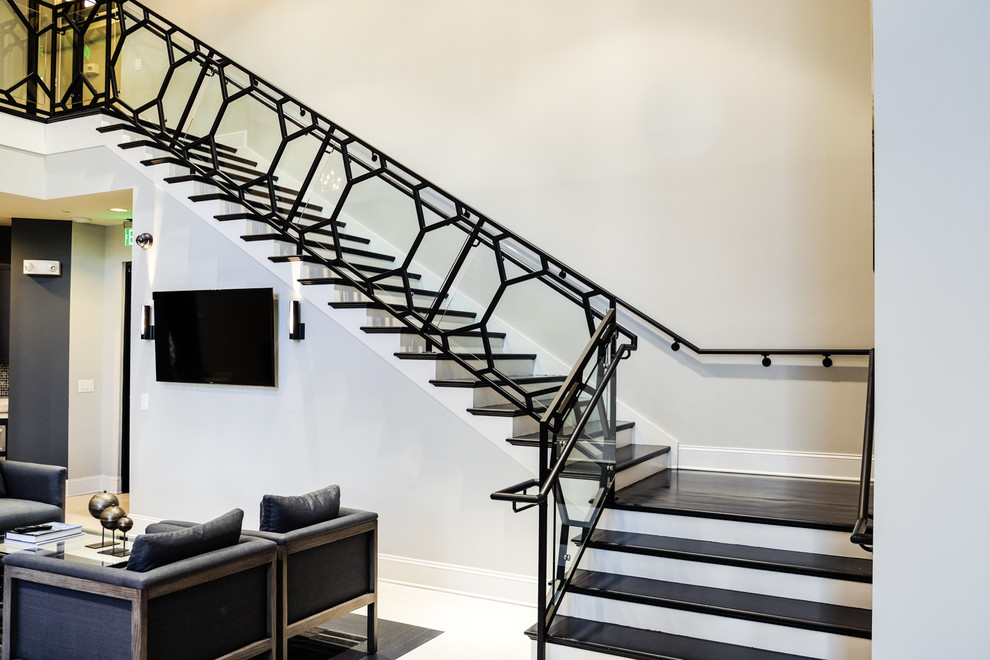 Example of a minimalist wooden staircase design in Atlanta with painted risers