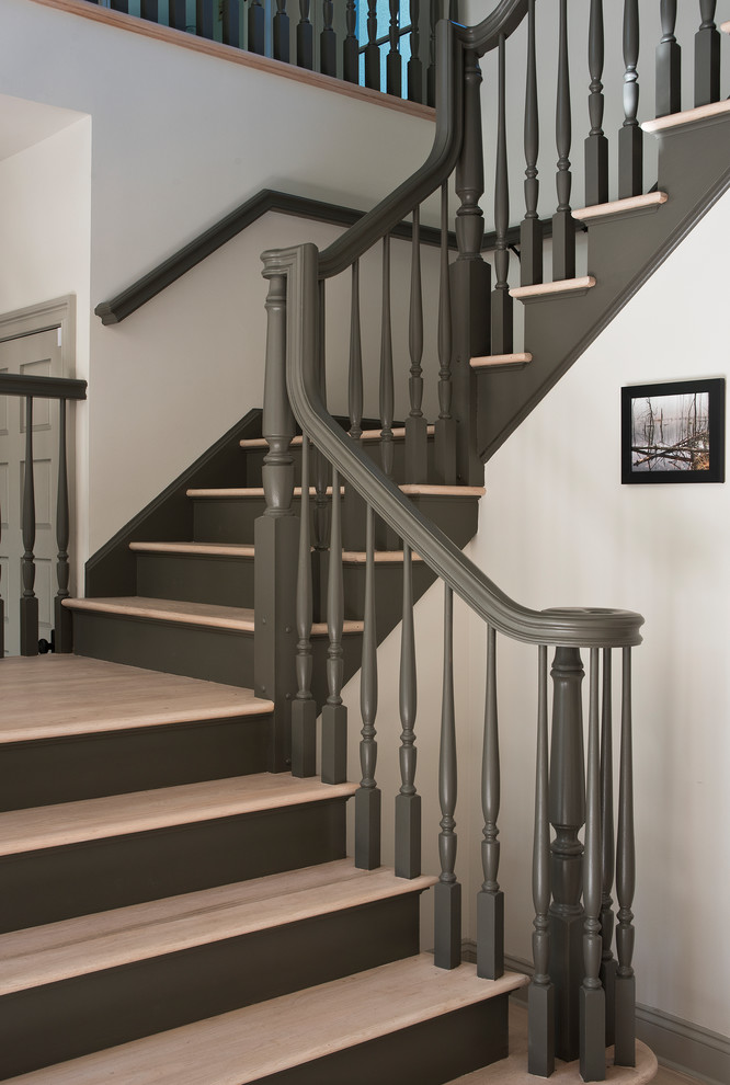 Photo of a medium sized classic wood u-shaped wood railing staircase in New York with painted wood risers.
