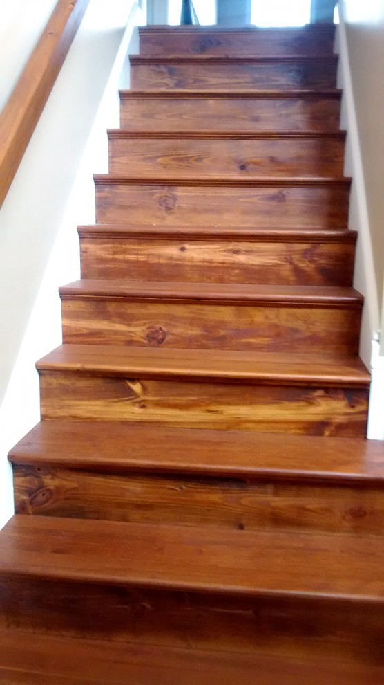 Medium sized rustic wood straight staircase in Other with wood risers.