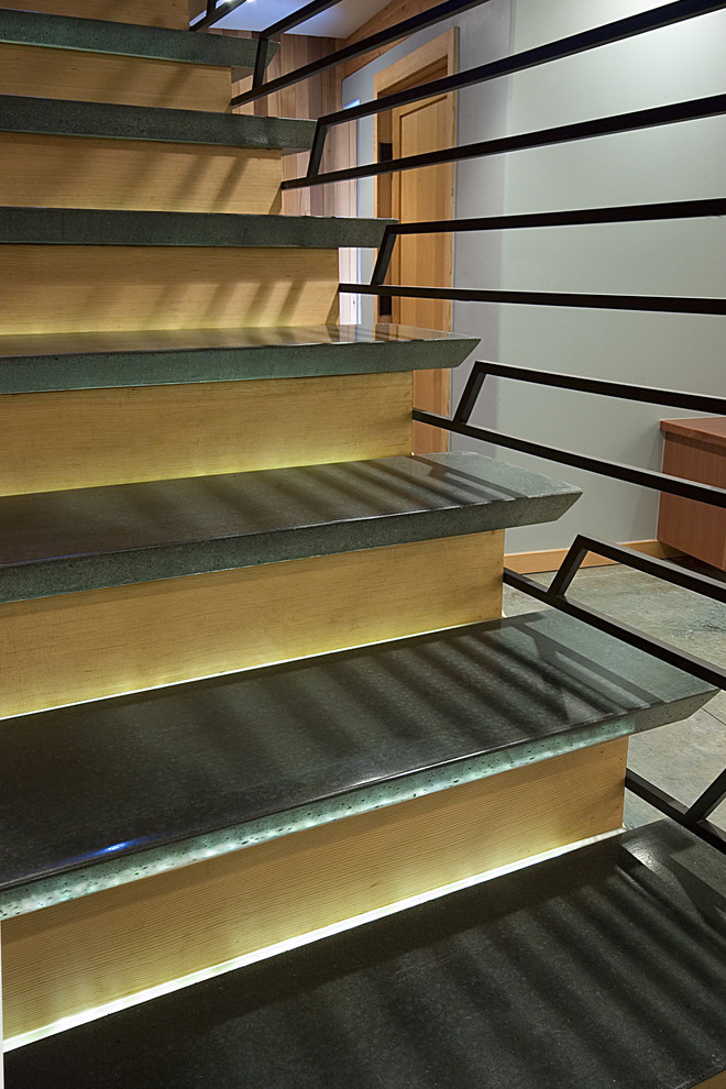 Medium sized modern concrete straight staircase in Seattle with wood risers.