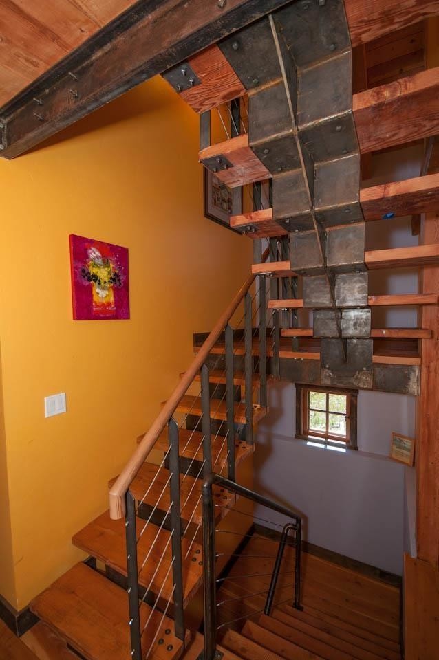 Photo of a medium sized modern wood u-shaped staircase in Other with metal risers.