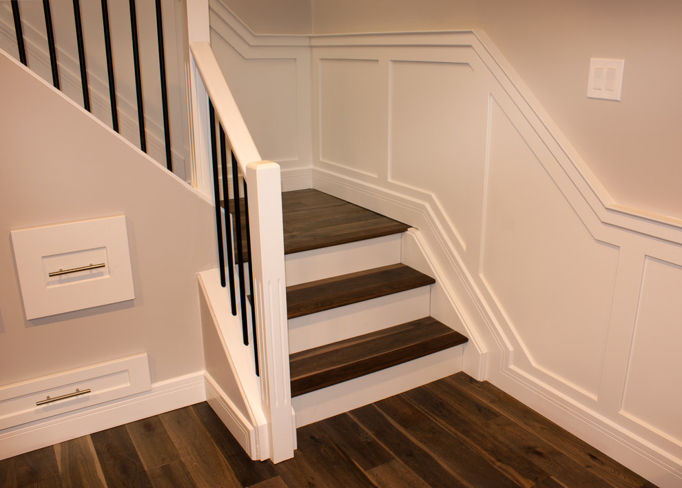 Inspiration for a timeless wooden l-shaped metal railing staircase remodel in Other with painted risers