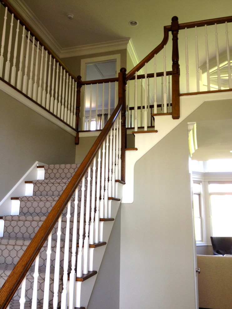 This is an example of a medium sized classic carpeted straight staircase in Other with carpeted risers.