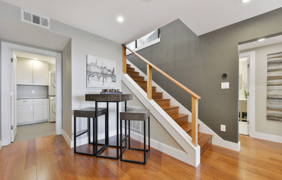 Inspiration for a large classic wood straight wood railing staircase in San Francisco with wood risers.
