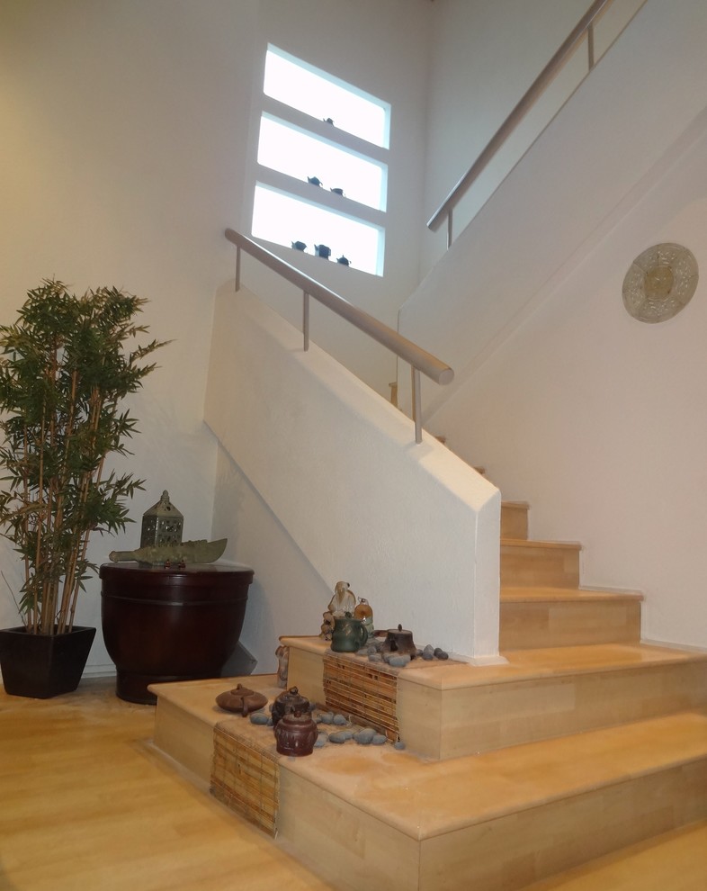 Staircase - mid-sized modern wooden u-shaped metal railing staircase idea in Orange County with wooden risers