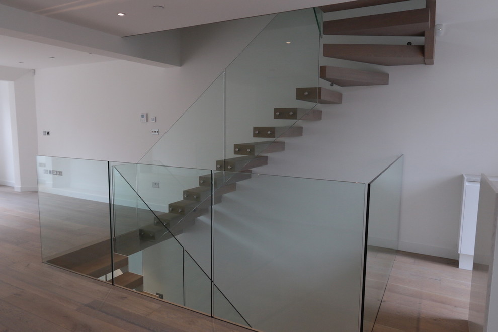 Staircase - large contemporary wooden floating staircase idea in London