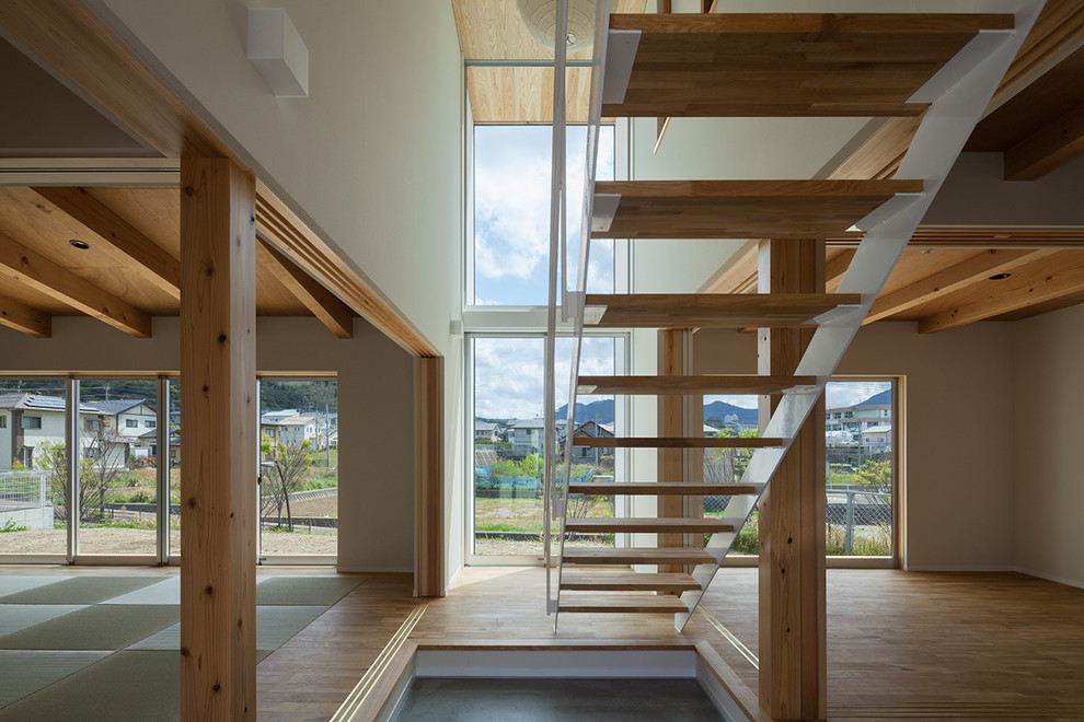 Trendy wooden open staircase photo in Other