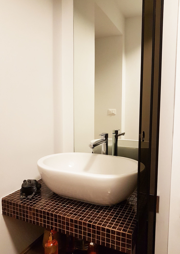 Idéer för att renovera ett litet funkis badrum med dusch, med öppna hyllor, en öppen dusch, en toalettstol med hel cisternkåpa, brun kakel, porslinskakel, vita väggar, klinkergolv i porslin, ett fristående handfat, kaklad bänkskiva, brunt golv och med dusch som är öppen