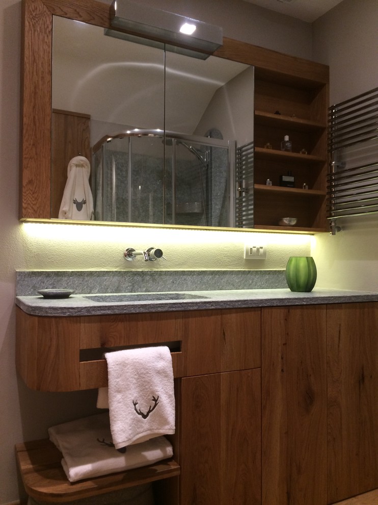 Idée de décoration pour une salle de bain principale minimaliste en bois brun de taille moyenne avec un placard à porte plane, une douche d'angle, WC suspendus, un mur blanc, parquet clair et un lavabo encastré.