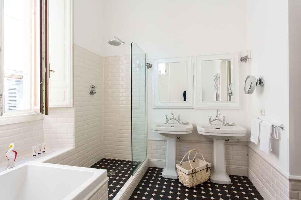 Photo of a mediterranean cream and black ensuite bathroom in Rome with a built-in bath, a corner shower, white tiles, metro tiles, white walls, a pedestal sink, black floors and an open shower.